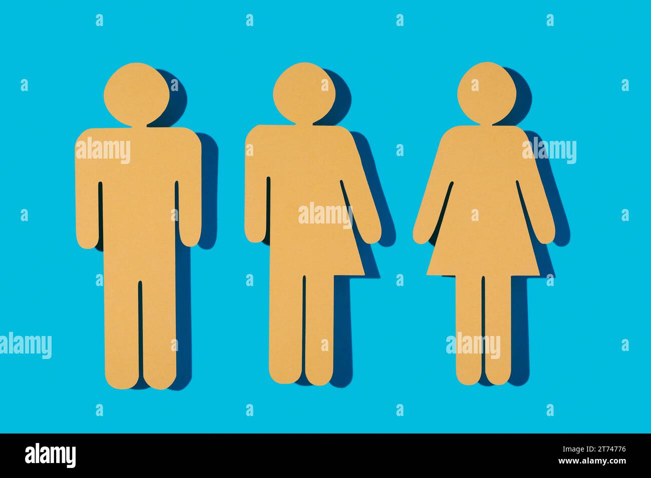 three yellow gender icons on a blue background, a male gender icon, a gender neutral icon and a female gender icon Stock Photo
