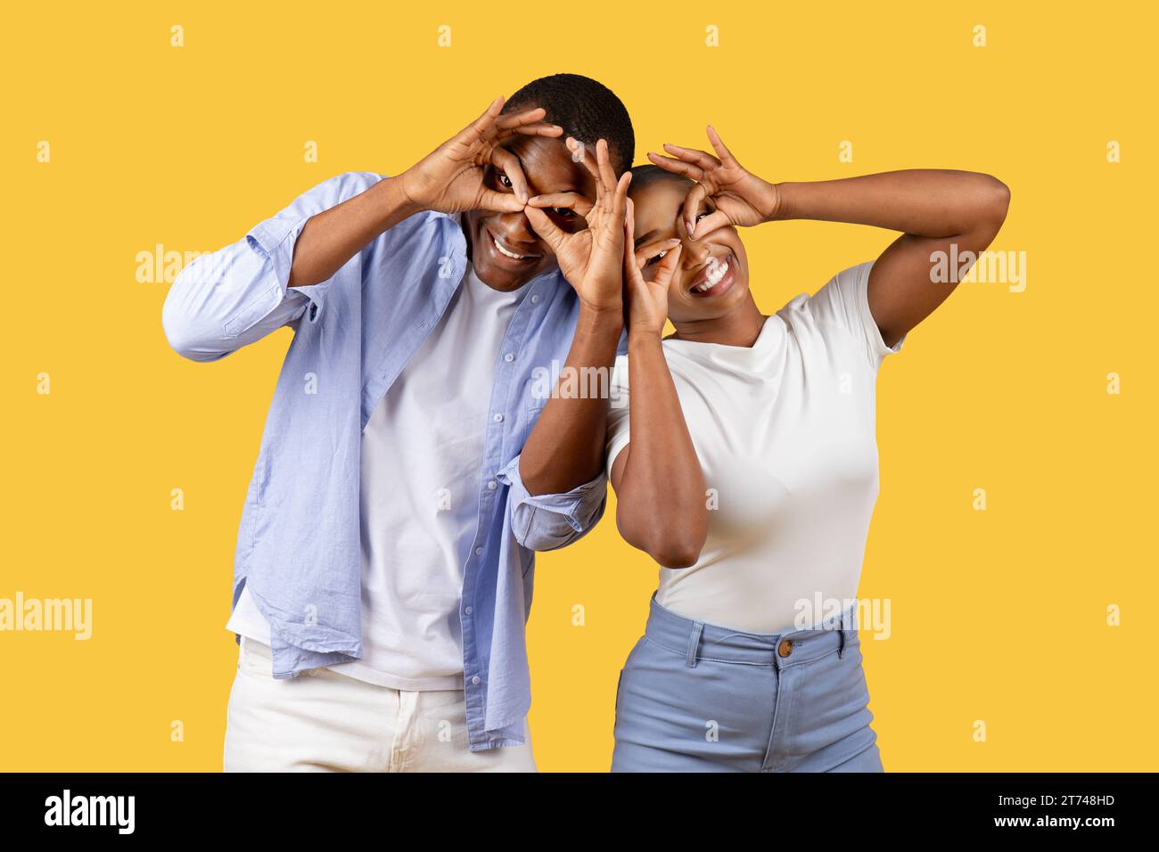Black couple making fun glasses with fingers Stock Photo