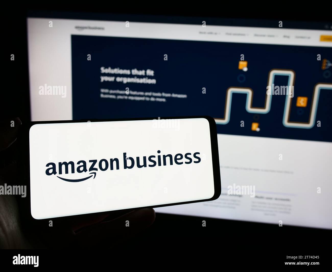 Person holding cellphone with logo of American B2B platform