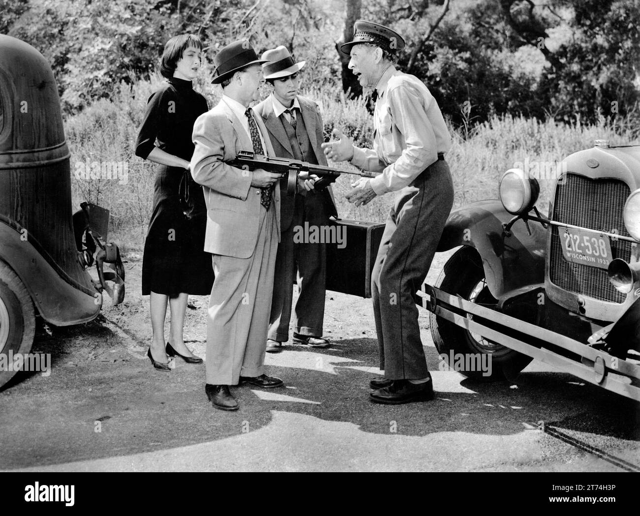 Carolyn Jones, Mickey Rooney (with gun), Dan Terranova (2nd right), Tom Fadden (right), on-set of the film, 'Baby Face Nelson', United Artists, 1957 Stock Photo