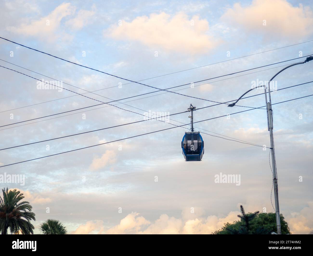 Cabins on a rope. Ropeway. Cabin silhouette. Road in the city on a lift ...