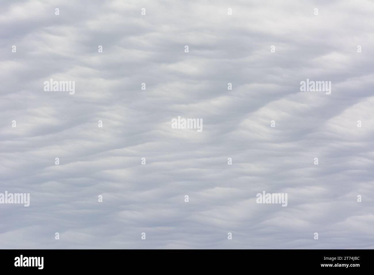 Abstract cloud texture with a wavy, sand dune pattern. Stock Photo