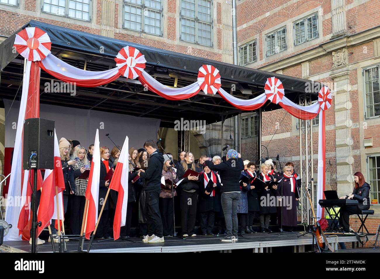 GDANSK, POLAND - 11 NOVEMBER 2023: A choir sings patriotic songs frrom an outdoor stage on Ulica Długa for Polish Independence Day Stock Photo