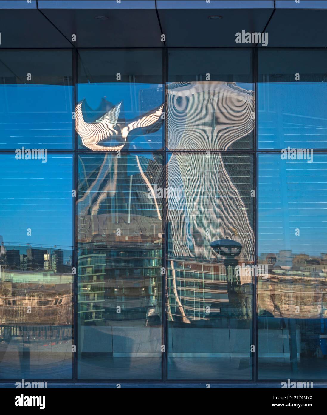 The distorted reflection of The Walkie Talkie building in an office ...