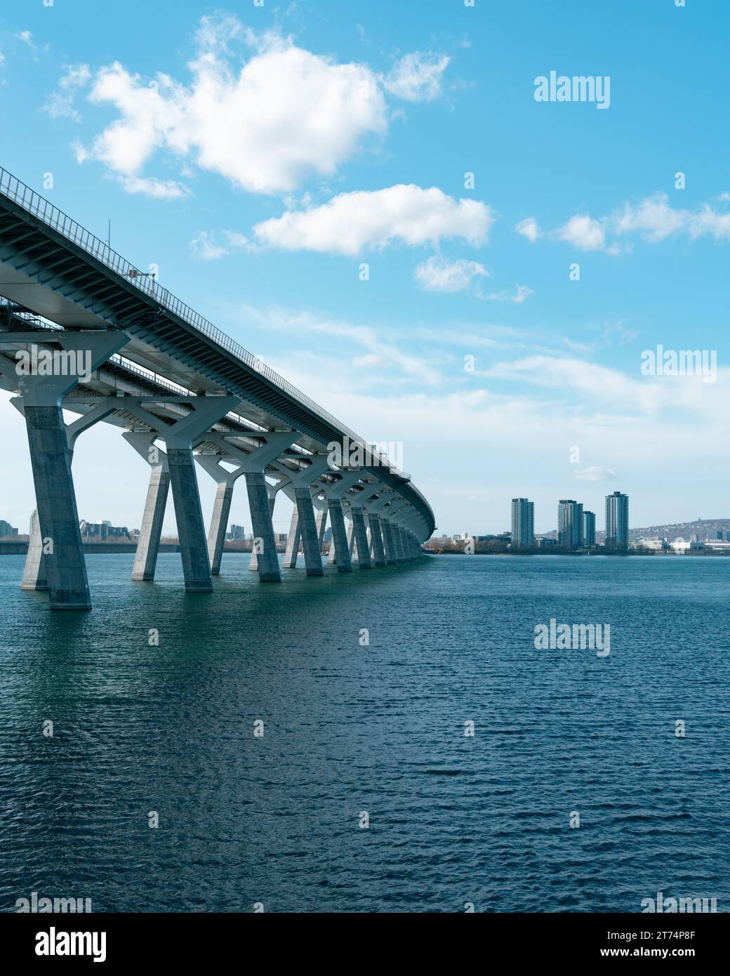 A scenic view of a bridge spanning across a tranquil body of water in a city park Stock Photo