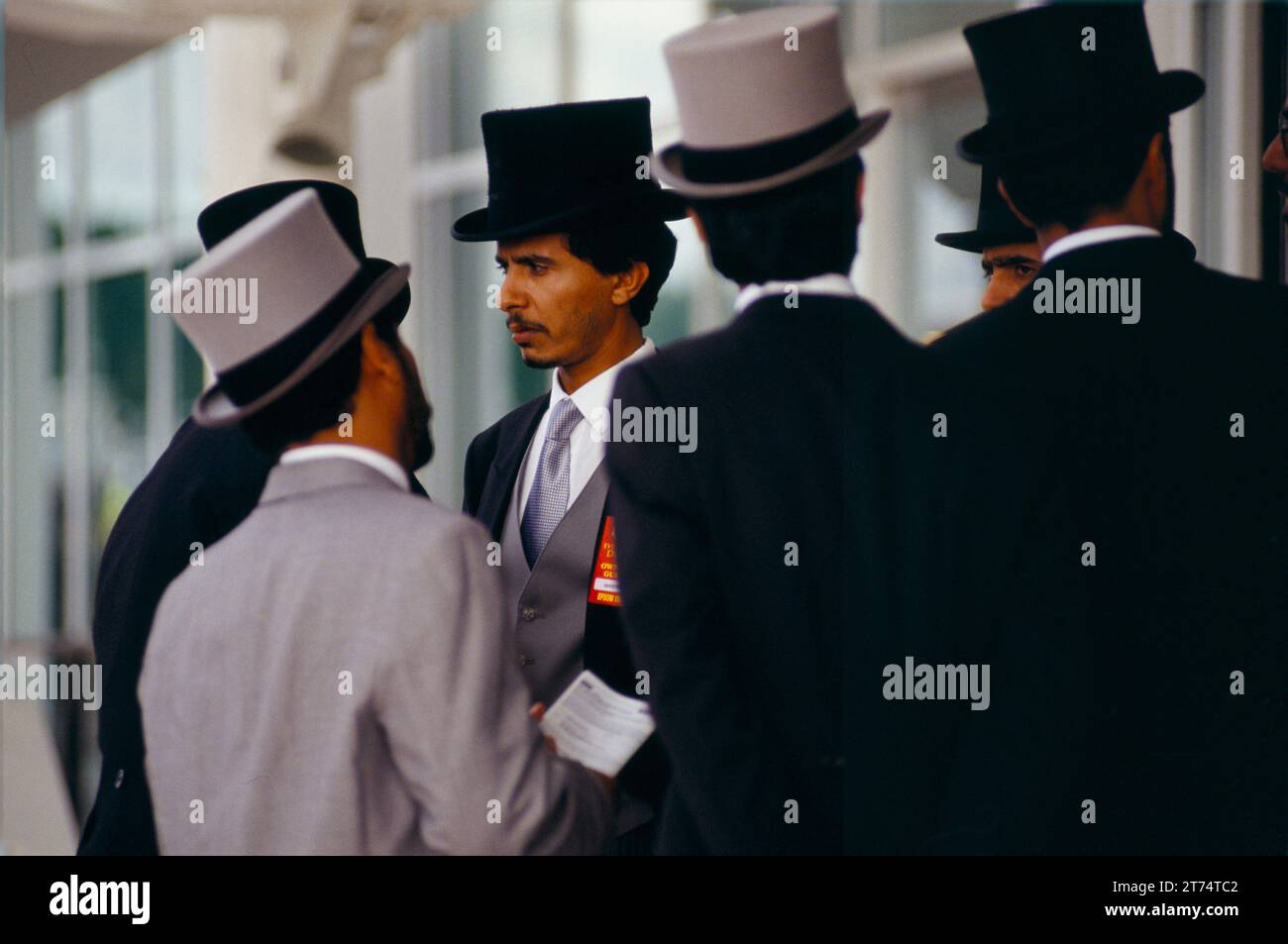 Arab men in western dress top hat and tails coats who are all part of Sheikh Mohammed Al Maktoum entourage horse racing at Royal Ascot in the Members Enclosure. Berkshire  England circa June 1983. 1980s UK HOMER SYKES Stock Photo
