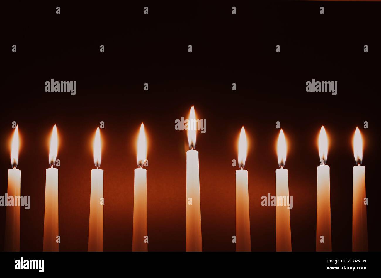 Hanukkah candles. Traditional candelabrum with burning candles on black