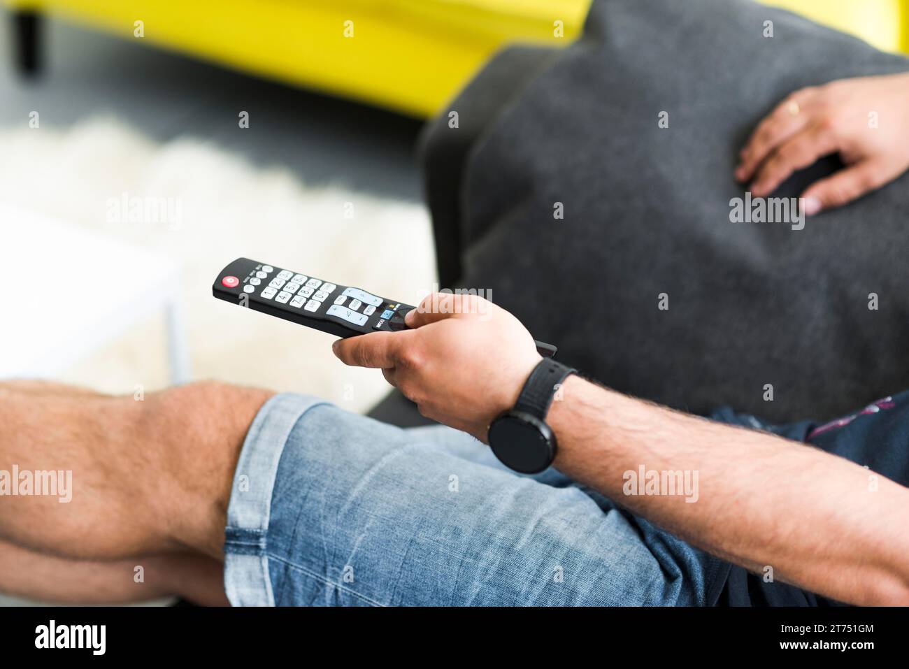 Close up man s hand holding television remote control Stock Photo