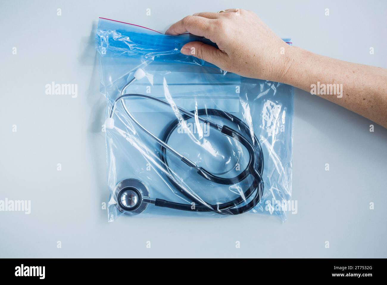 Human hand holding zip lock plastic bag with stethoscope Stock Photo