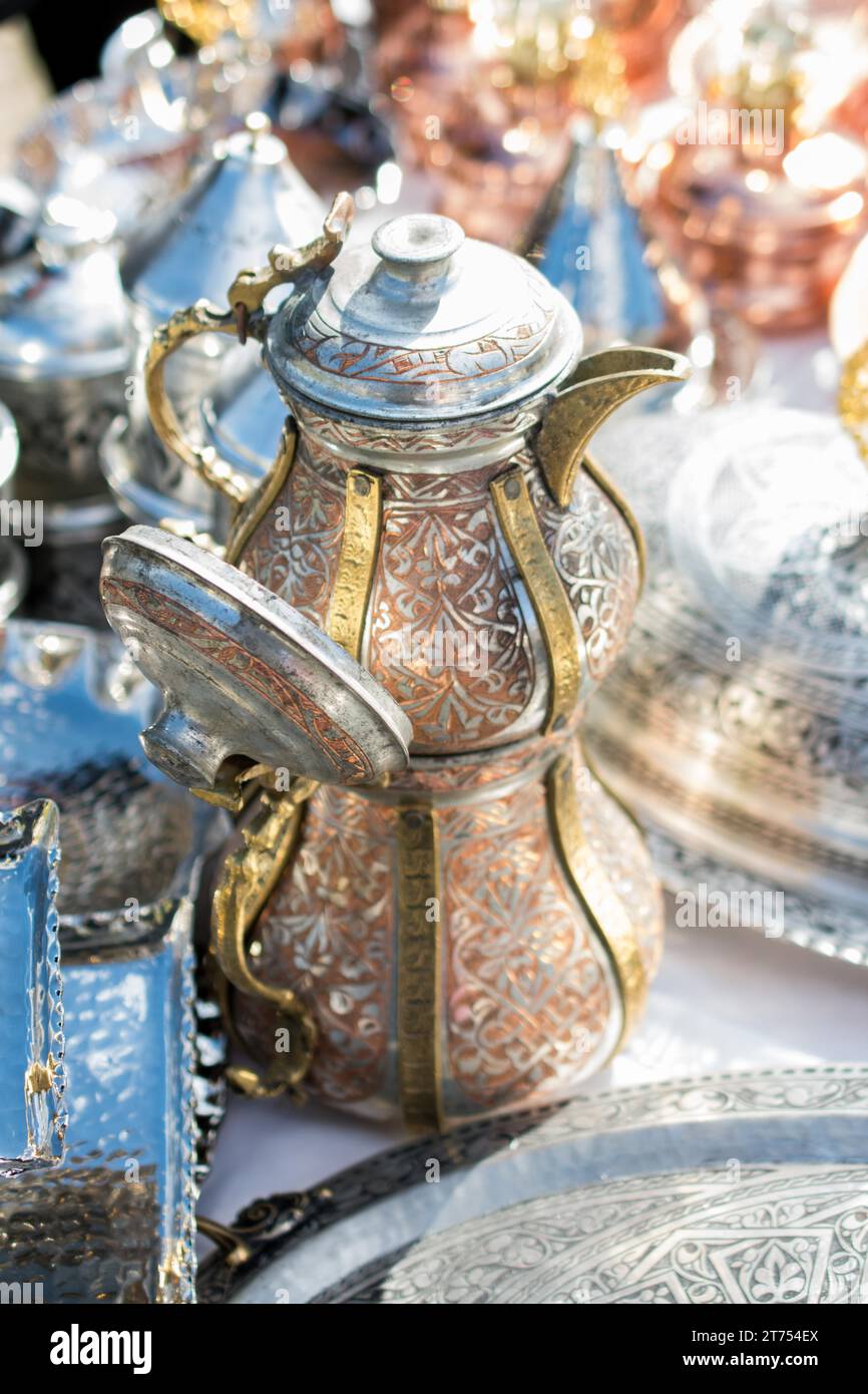 Ancient metal jug in oriental style in antique market Stock Photo