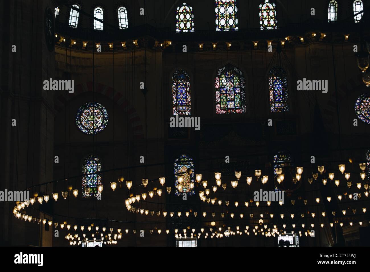 Bright Lamps on circular chandelier in a big mosque Stock Photo