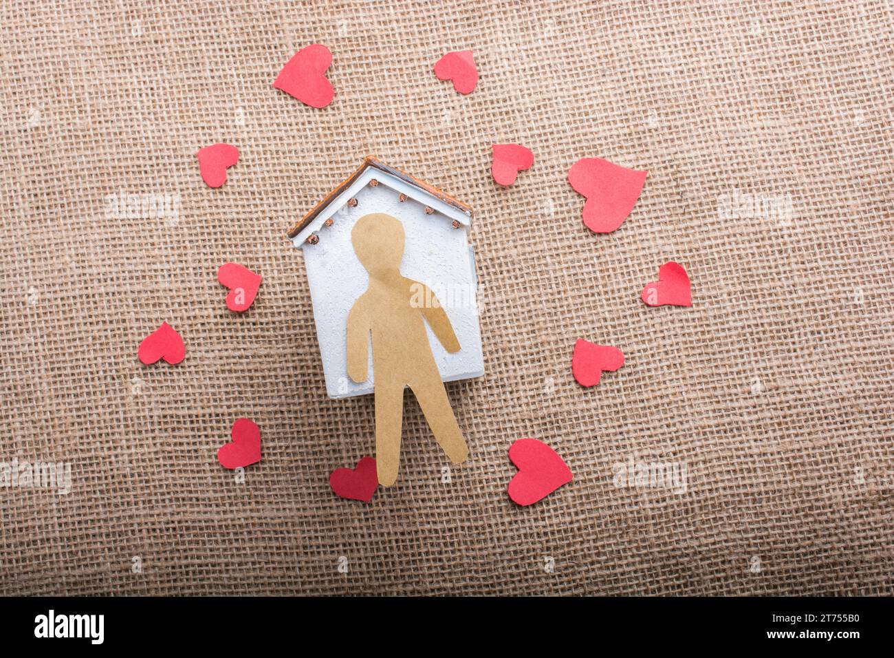 Heart shaped icons and paper house on canvas Stock Photo - Alamy