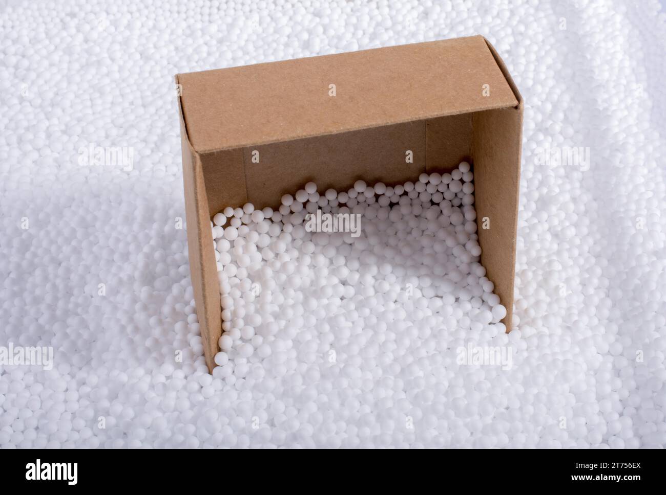 Box on little white polystyrene foam balls Stock Photo