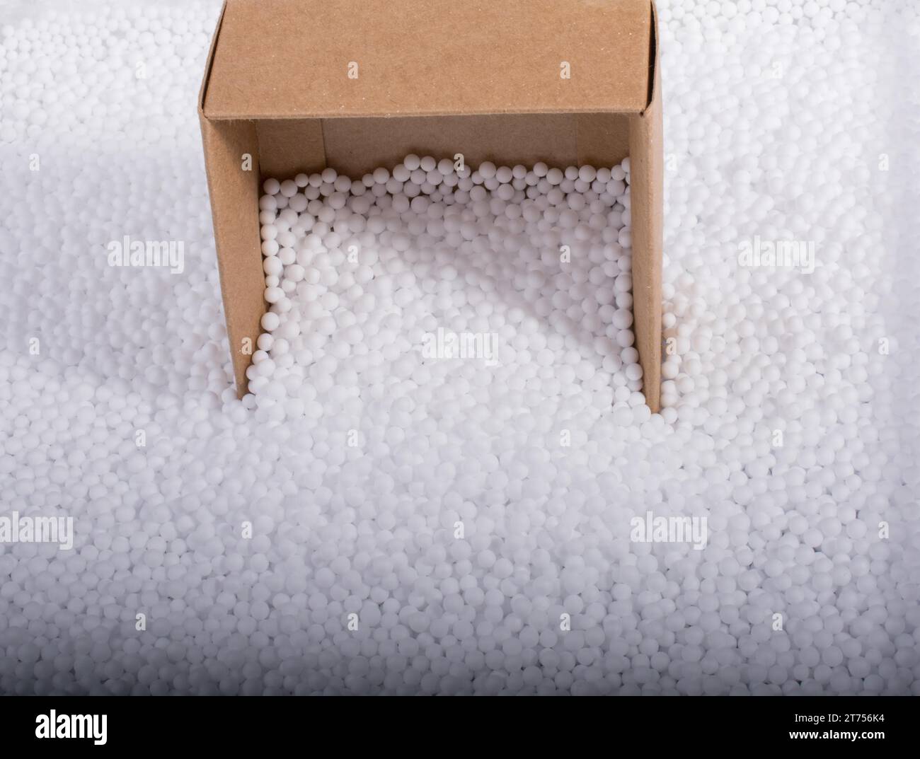Box on little white polystyrene foam balls Stock Photo