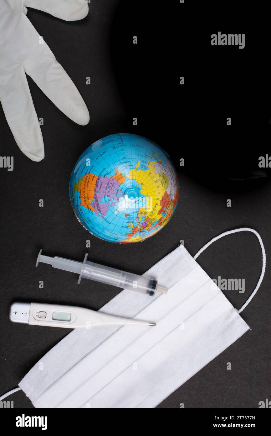 Coronavirus 2019 Pandemic. World epidemic concept. Mask, globes, gloved, syringe Stock Photo