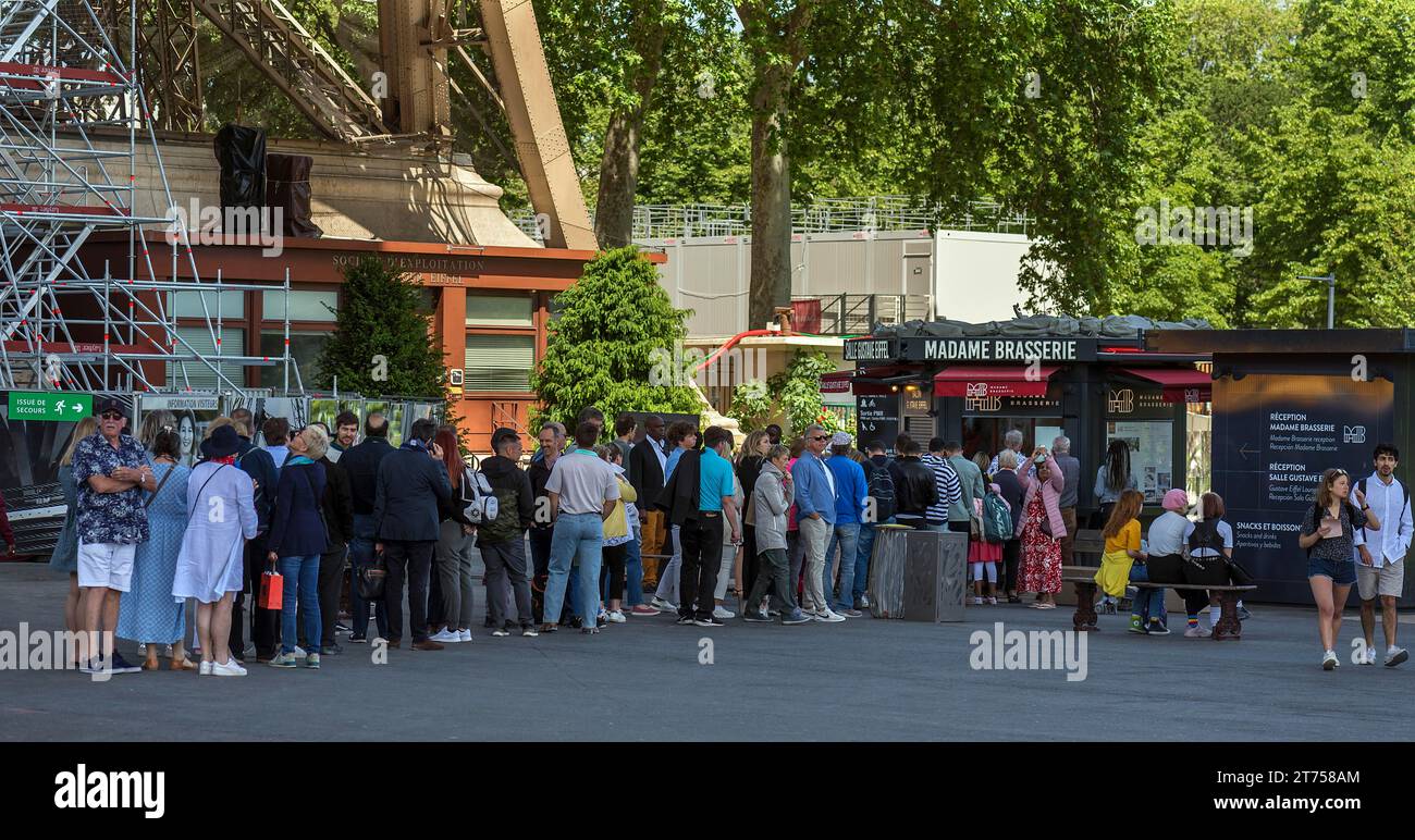 Queue in front of a brasserie below the Eiffel Tower, Paris, France Stock Photo