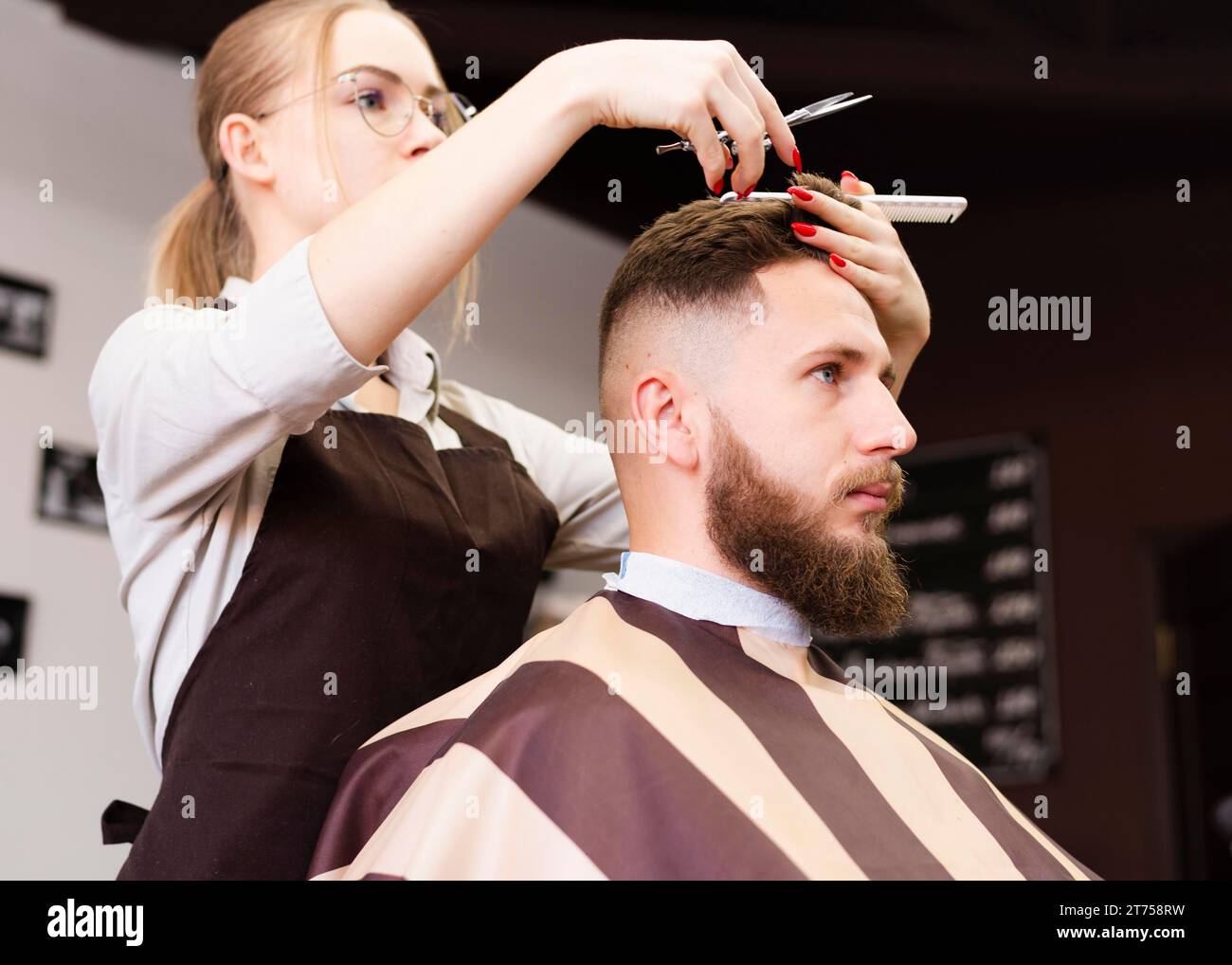 Barber shop worker doing her job Stock Photo