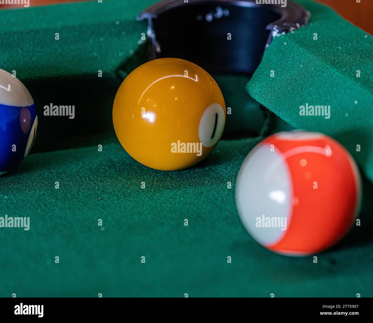 Billiard table setup featuring colorful pool balls, ready for an