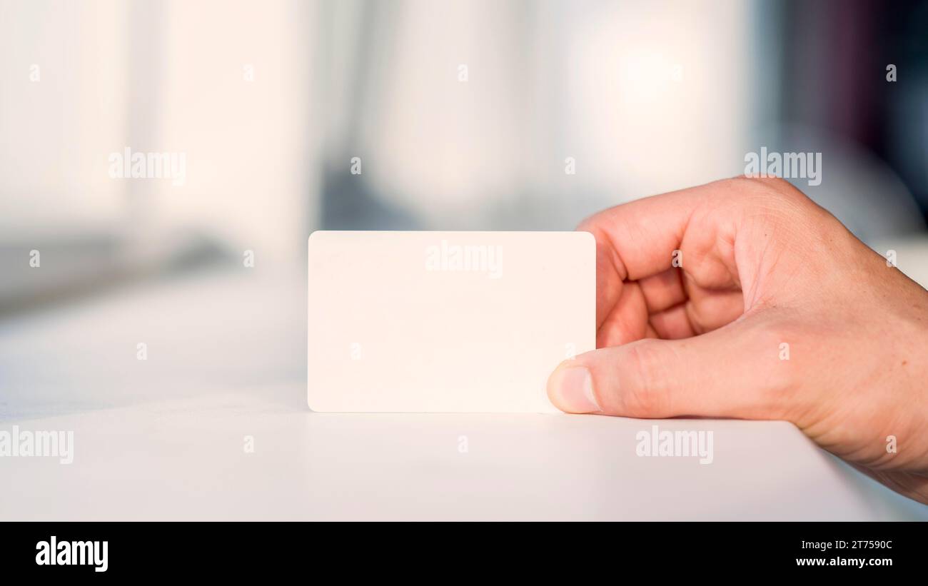Businessperson s hand holding blank white card Stock Photo