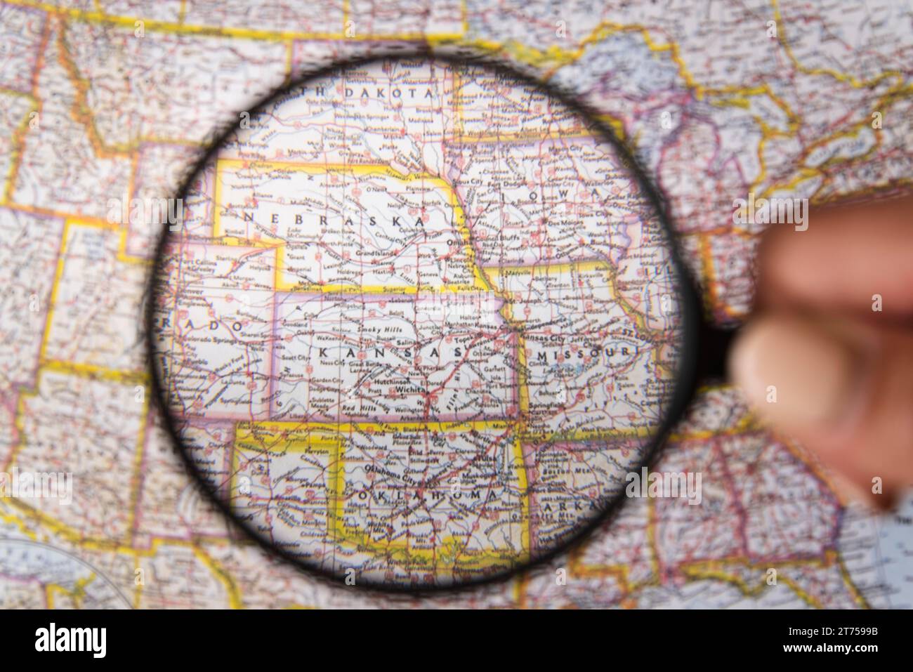 Close up magnifying glass showing places map Stock Photo