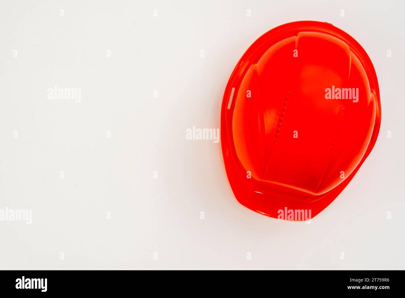 Flat lay red construction helmet white background Stock Photo