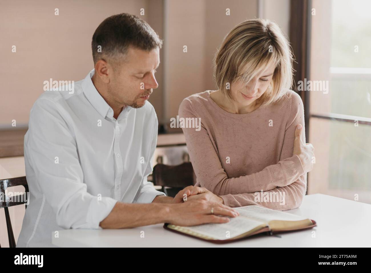 Husband wife reading bible Stock Photo