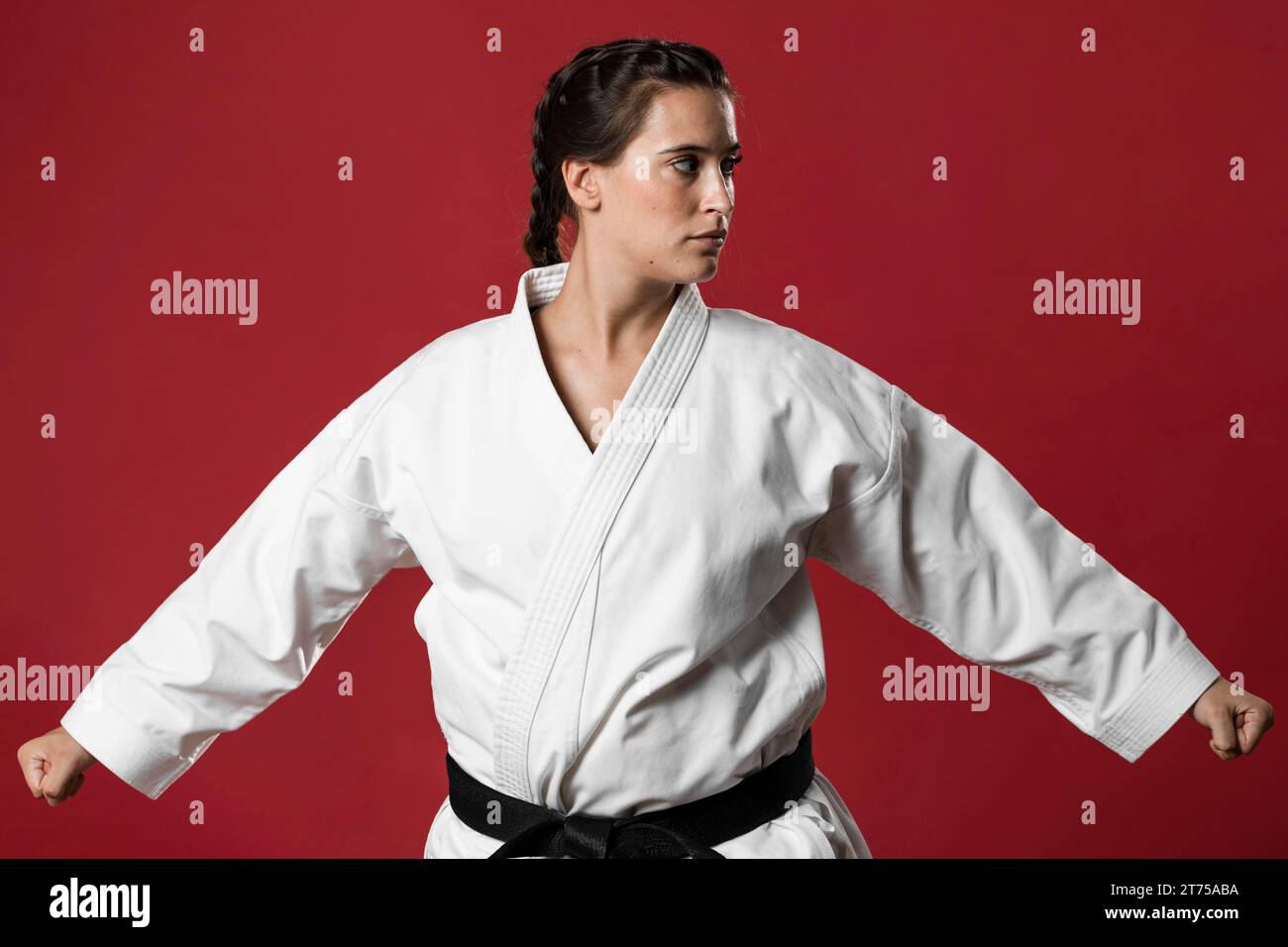 Karate woman action isolated red background Stock Photo