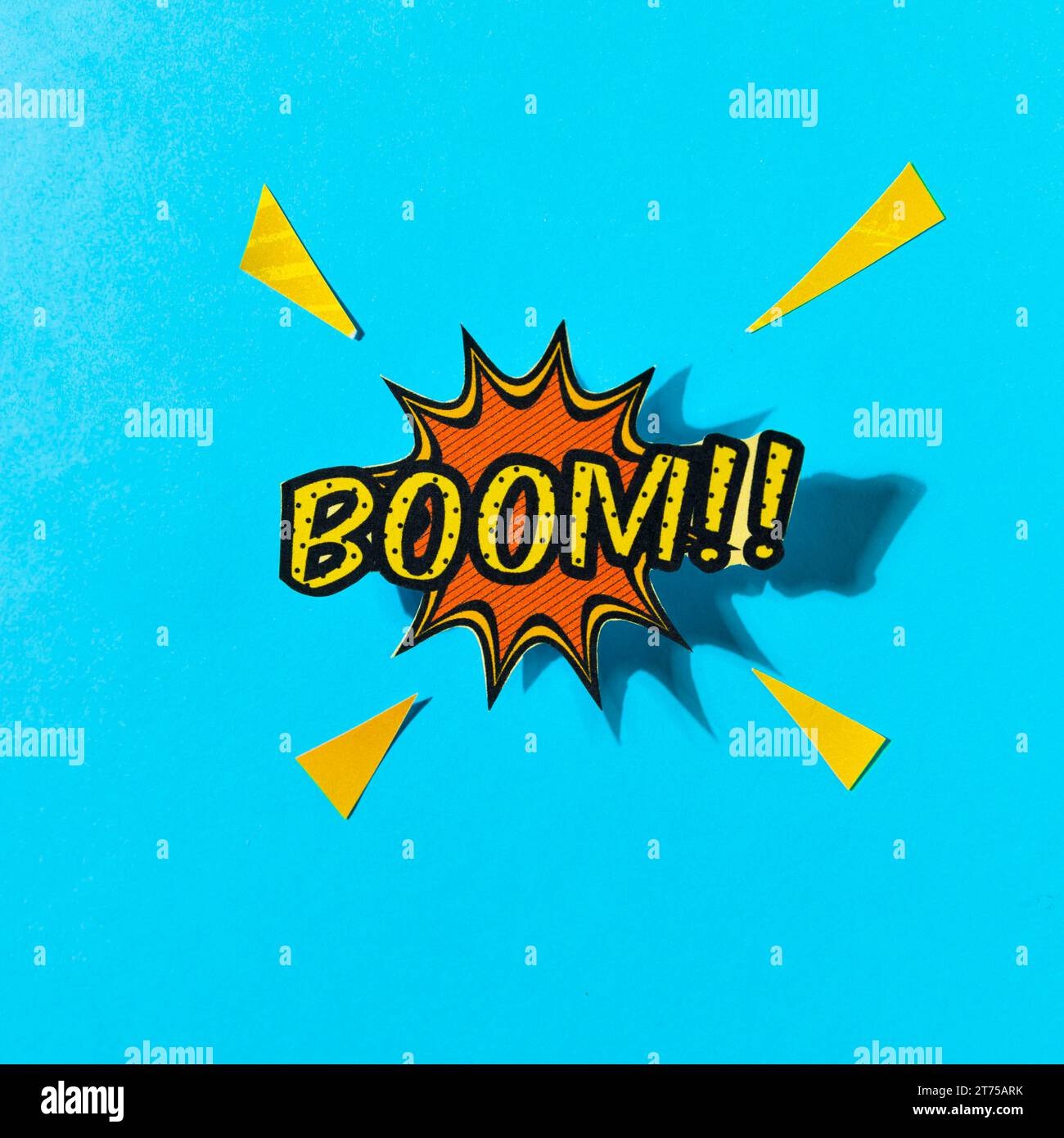 Pop art comics boom speech bubble against blue backdrop Stock Photo