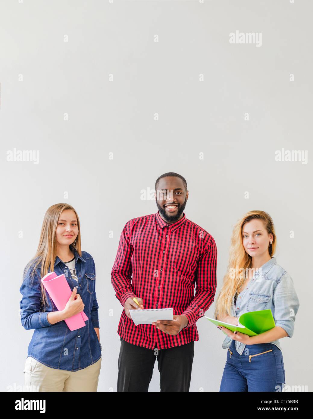 Successful students posing with notebooks Stock Photo