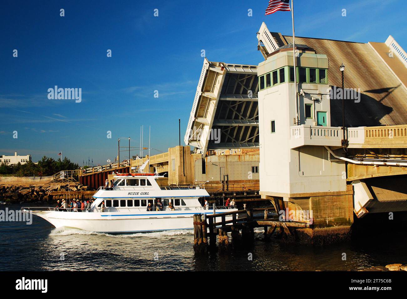 A Charter Fishing Boat Cruises under the Shark River Bridge in Belmar