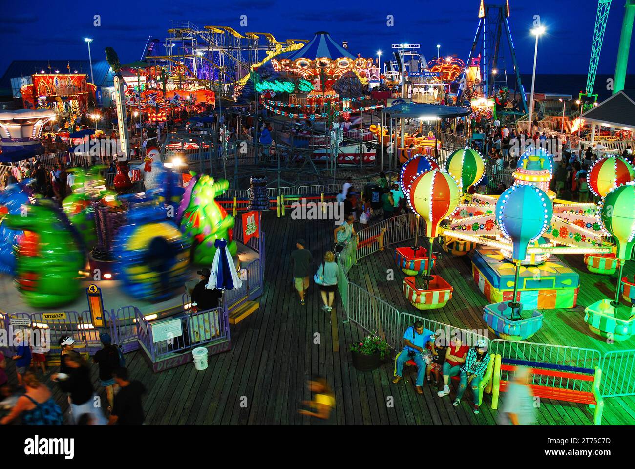 Casino Pier at Seaside Heights, on the Jersey shore, is illuminated with kiddie rides and thrill rides at the amusement park Stock Photo