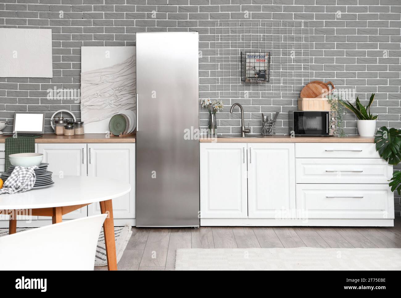 Interior of kitchen with stylish fridge, counters and table Stock Photo ...