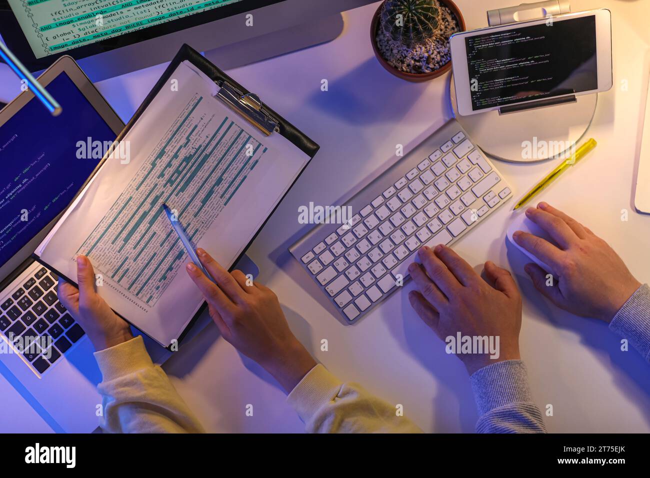 Programmers working in office at night, top view Stock Photo