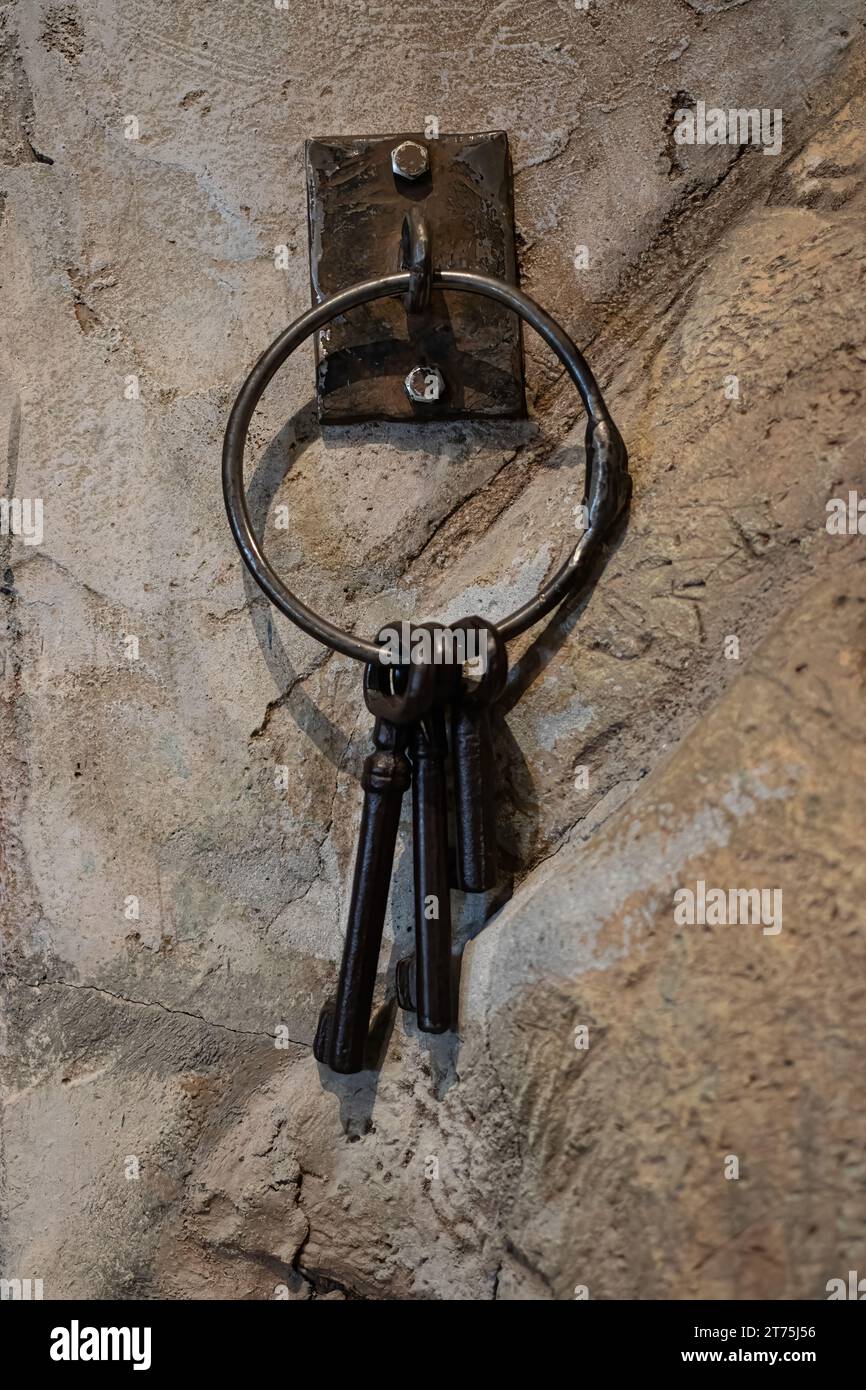 Rusty keys hanging near a old west jail house cage door. Stock Photo