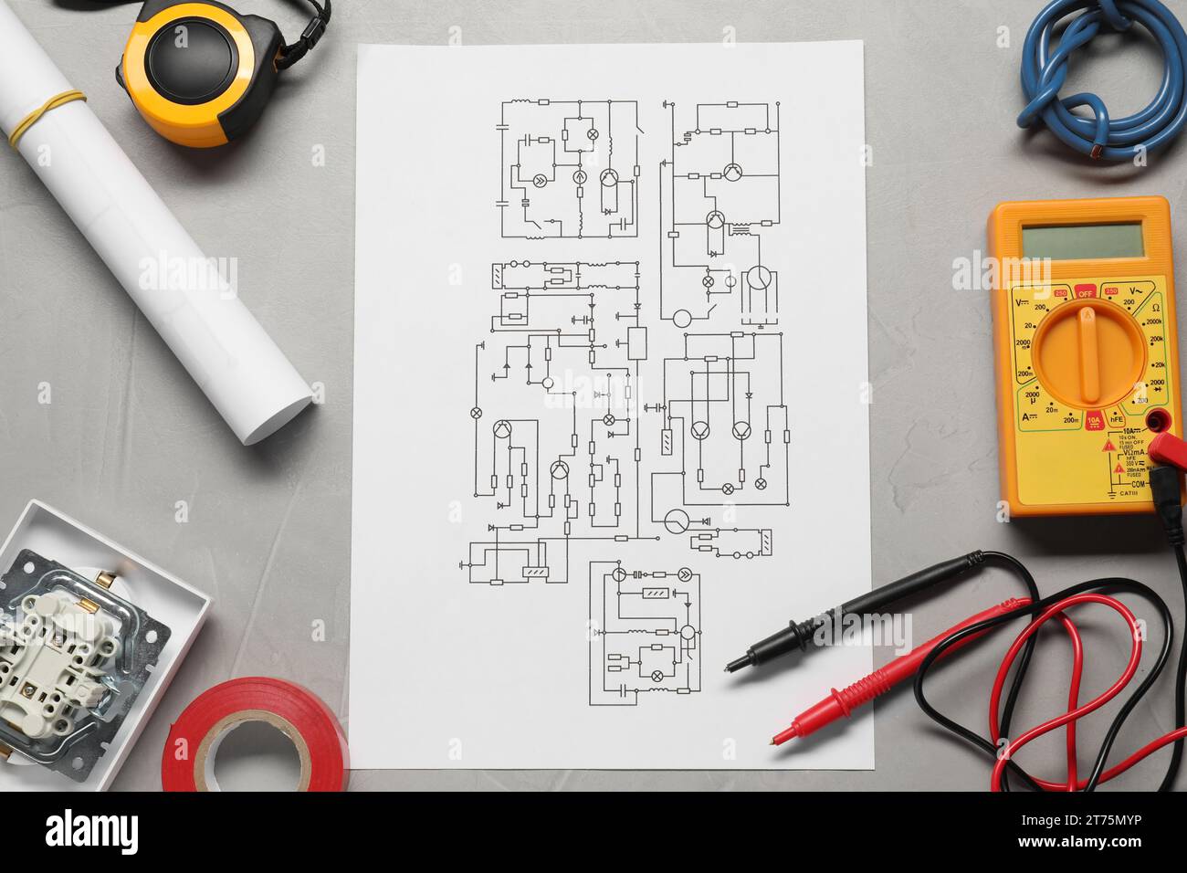 Wiring diagram, wires and digital multimeter on light grey table, flat lay Stock Photo