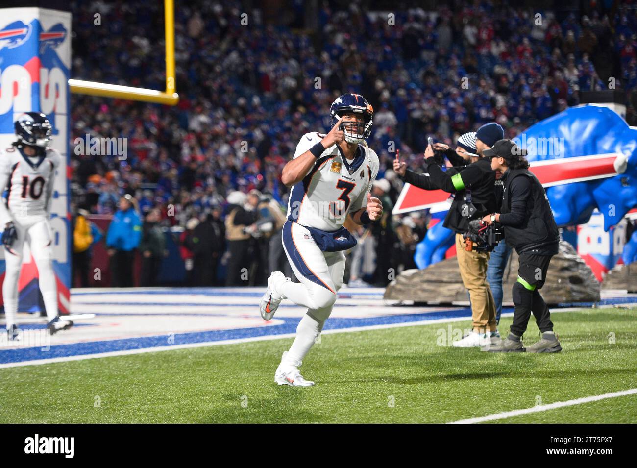 Denver Broncos quarterback Russell Wilson runs on the field before an ...