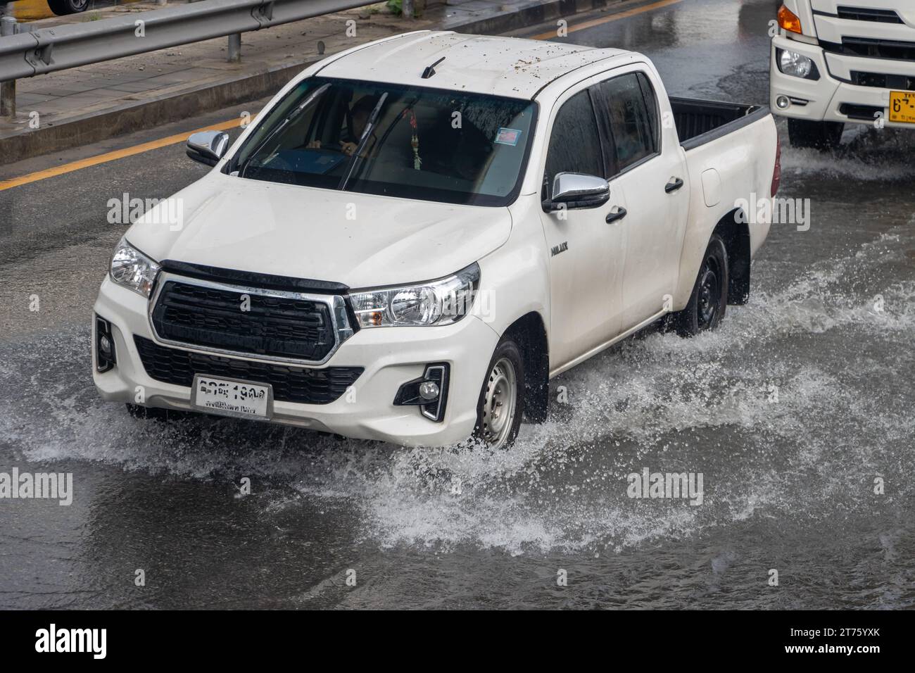 A pick up truck rides on a flooded highway in Bangkok, Thailand Stock Photo