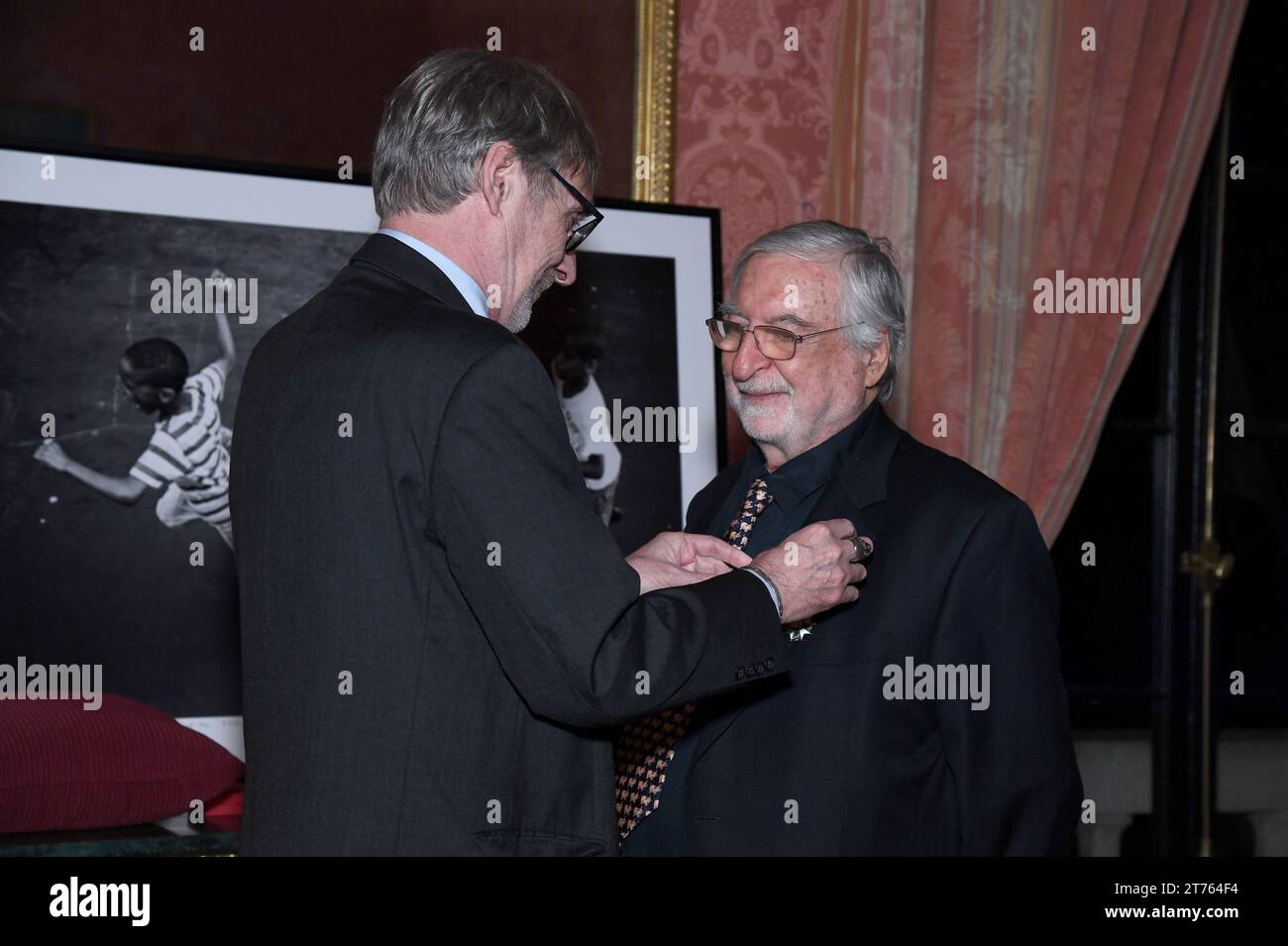 New York, USA. 13th Nov, 2023. French Photojournalist Jean-Francois Leroy (l) pins the the insignia of Knight in the National Order of the French Legion of Honor onto the lapel of French-American Photojournalist Jean-Pierre Laffont (r), ceremony held at the Consulat General de France in New York, NY, November 13, 2023. (Photo by Anthony Behar/Sipa USA) Credit: Sipa USA/Alamy Live News Stock Photo