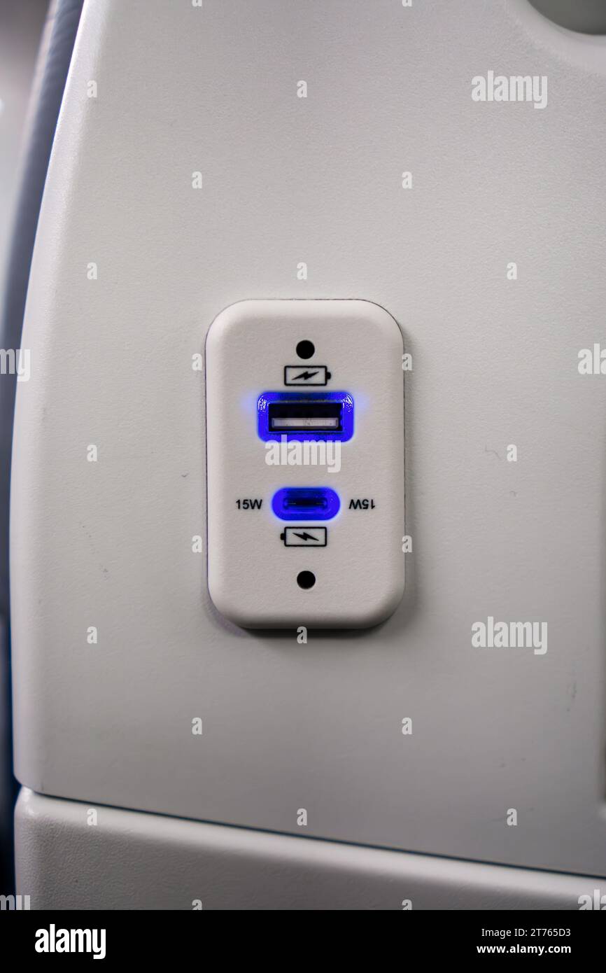 USB charging port for electronic devices on airplane seat Stock Photo