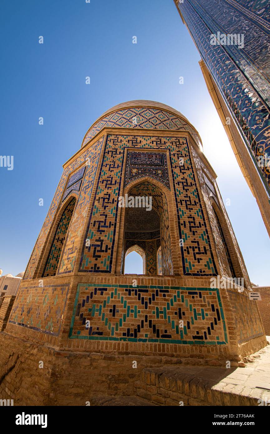 Historical cemetery of Shahi Zinda with its finely decorated mausoleums through an arch in Samarkand, Uzbekistan. Stock Photo