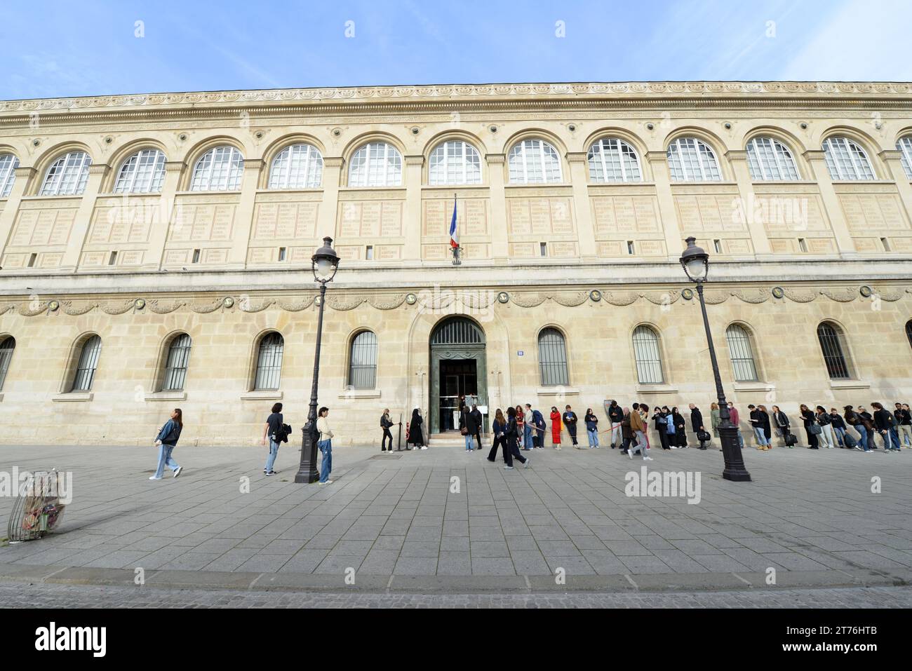 Students waiting in line in order to go into the Bibliothèque Sainte-Geneviève ( University Library ) of the Université Sorbonne Nouvelle in Paris. Stock Photo