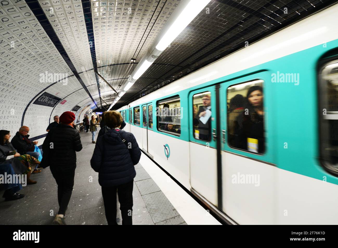 Passengers waiting for the Metro train at the Concorde Metro station in Paris, France. Stock Photo