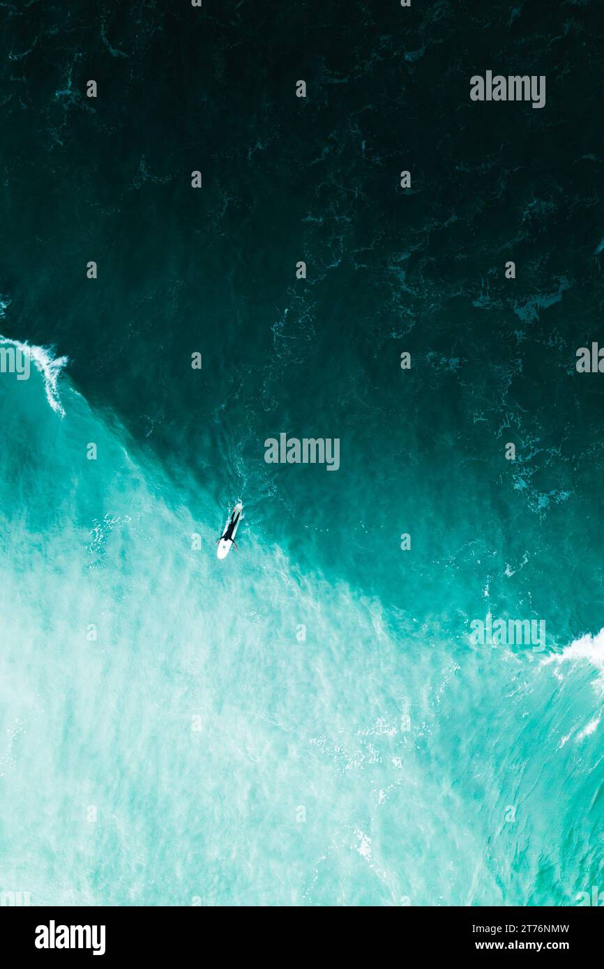 An aerial top view of person surfing in the sea waves in Florida Stock Photo