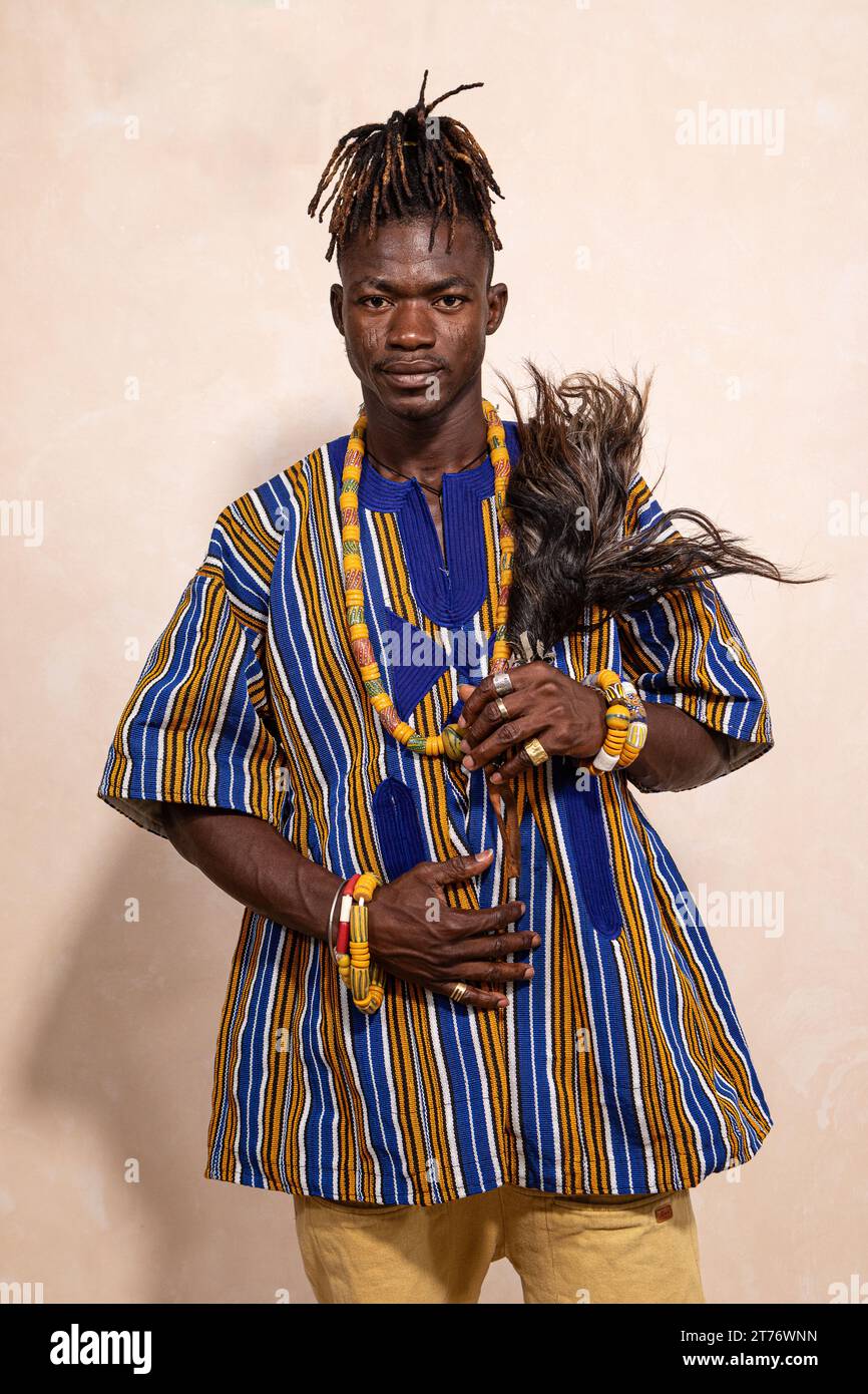 Portrait of a young African man with dreadlocks and elegantly dressed ...