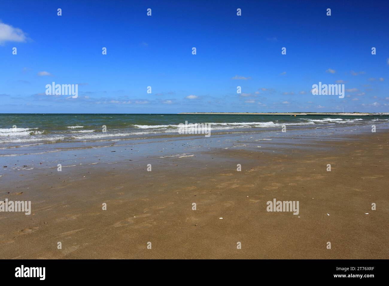 Waves with whitecaps flood the sandy beach,at the Netherlands Stock Photo