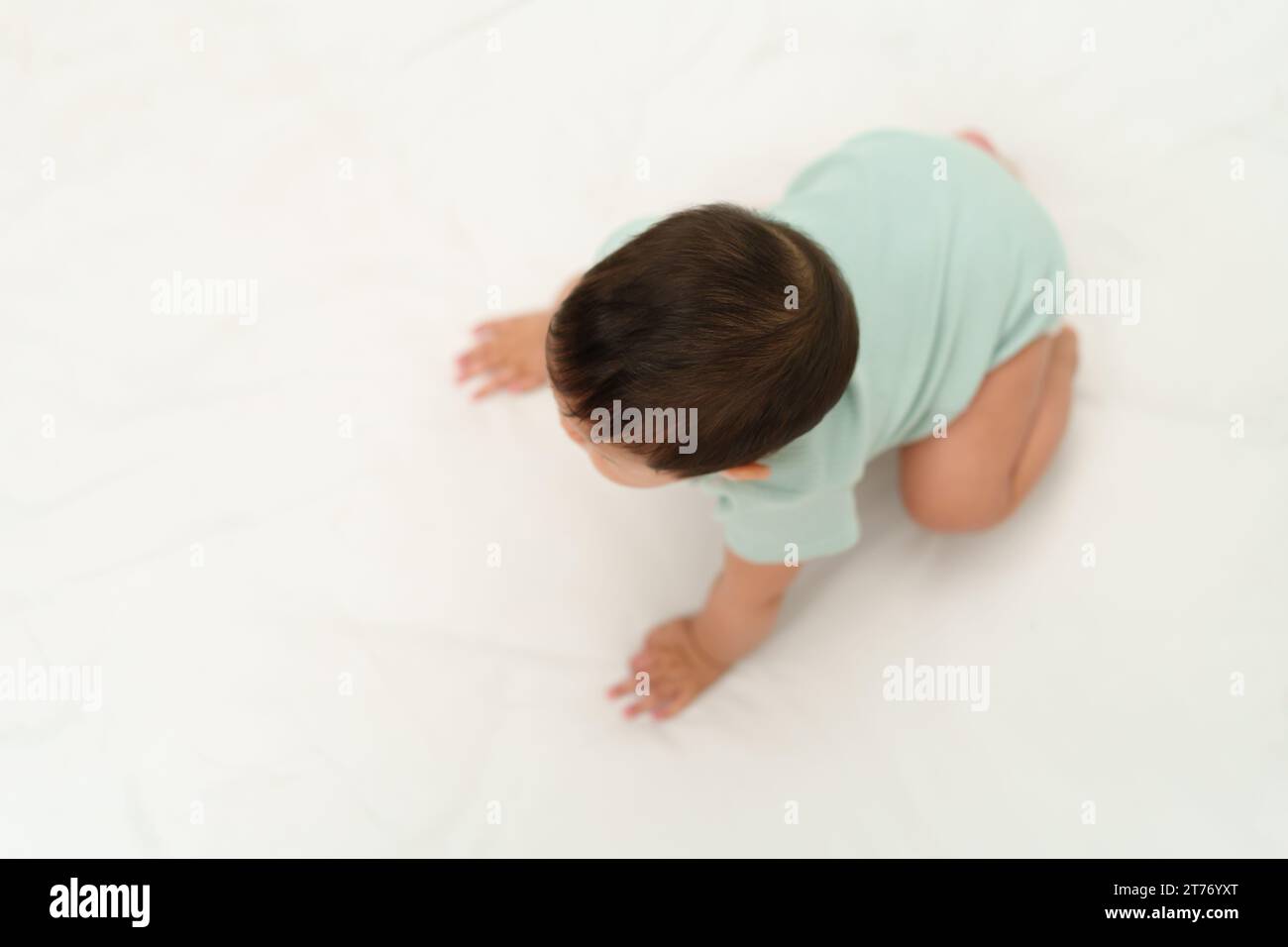 infant crawling on floor inside a baby playpen Stock Photo Alamy
