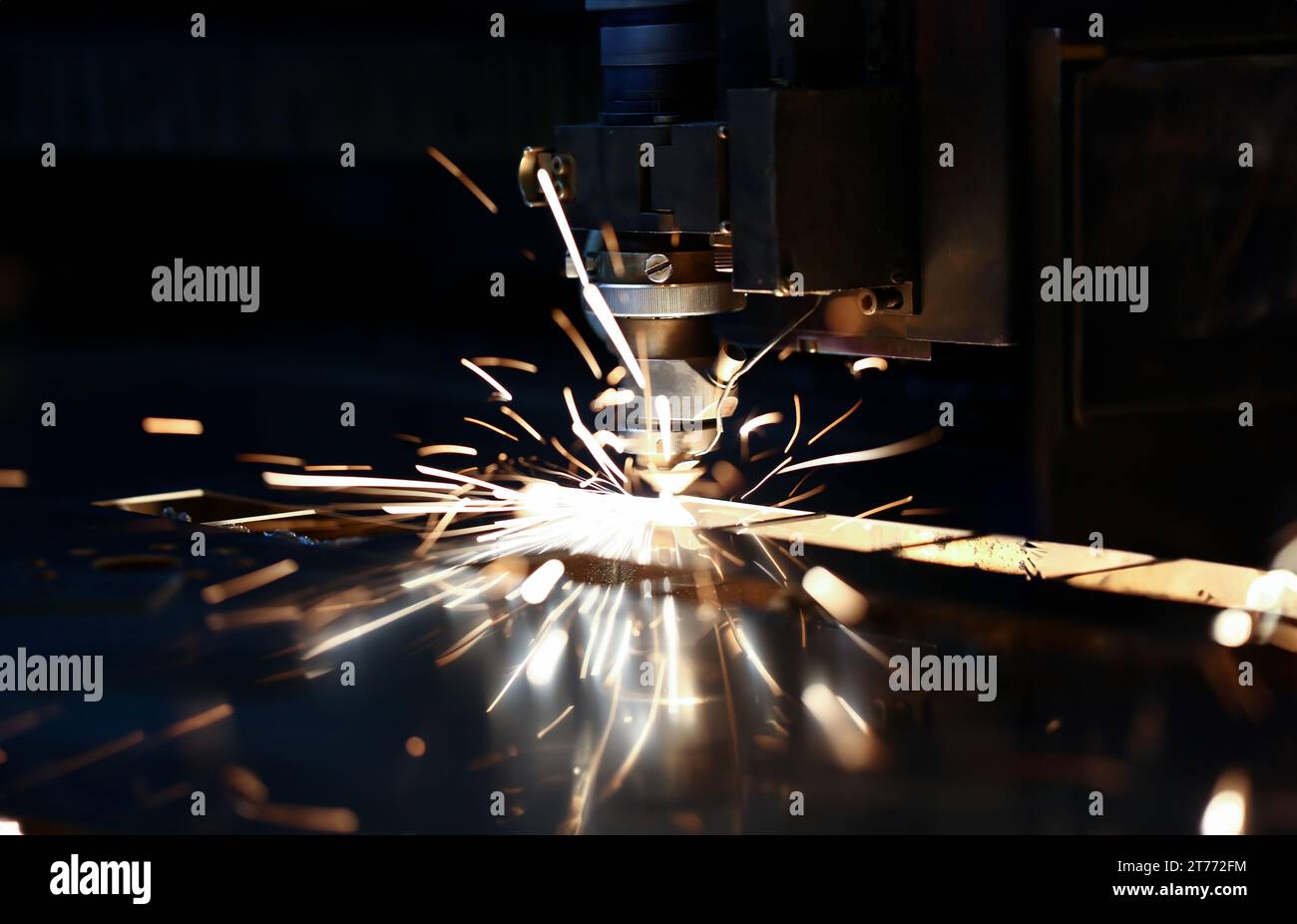 Sparks fly out machine head for metal processing Stock Photo