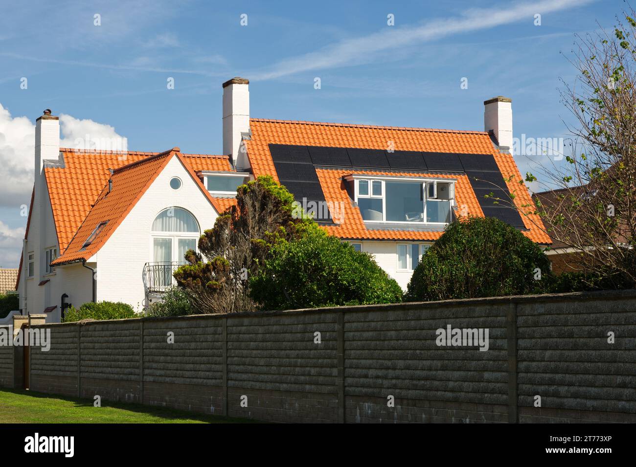 Modern house or mansion with solar panels behind wall on seafront at East Preston near Littlehampton in West Sussex, England. Stock Photo