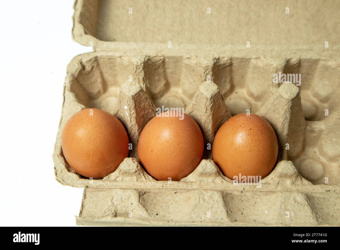 Eggs in a cardboard box isolated on a white background. Stock Photo