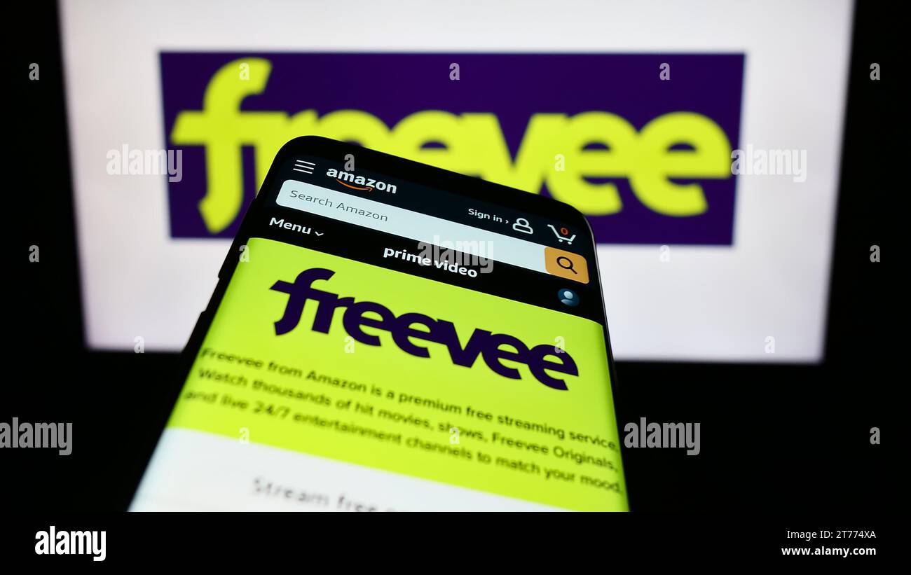 Mobile phone with website of US video-on-demand streaming service Amazon Freevee in front of business logo. Focus on top-left of phone display. Stock Photo